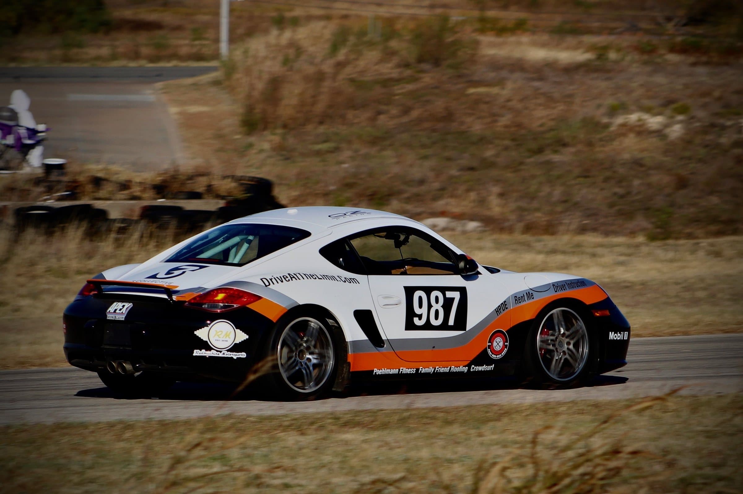 A track-prepped Porsche Cayman on track at Motorsport Ranch