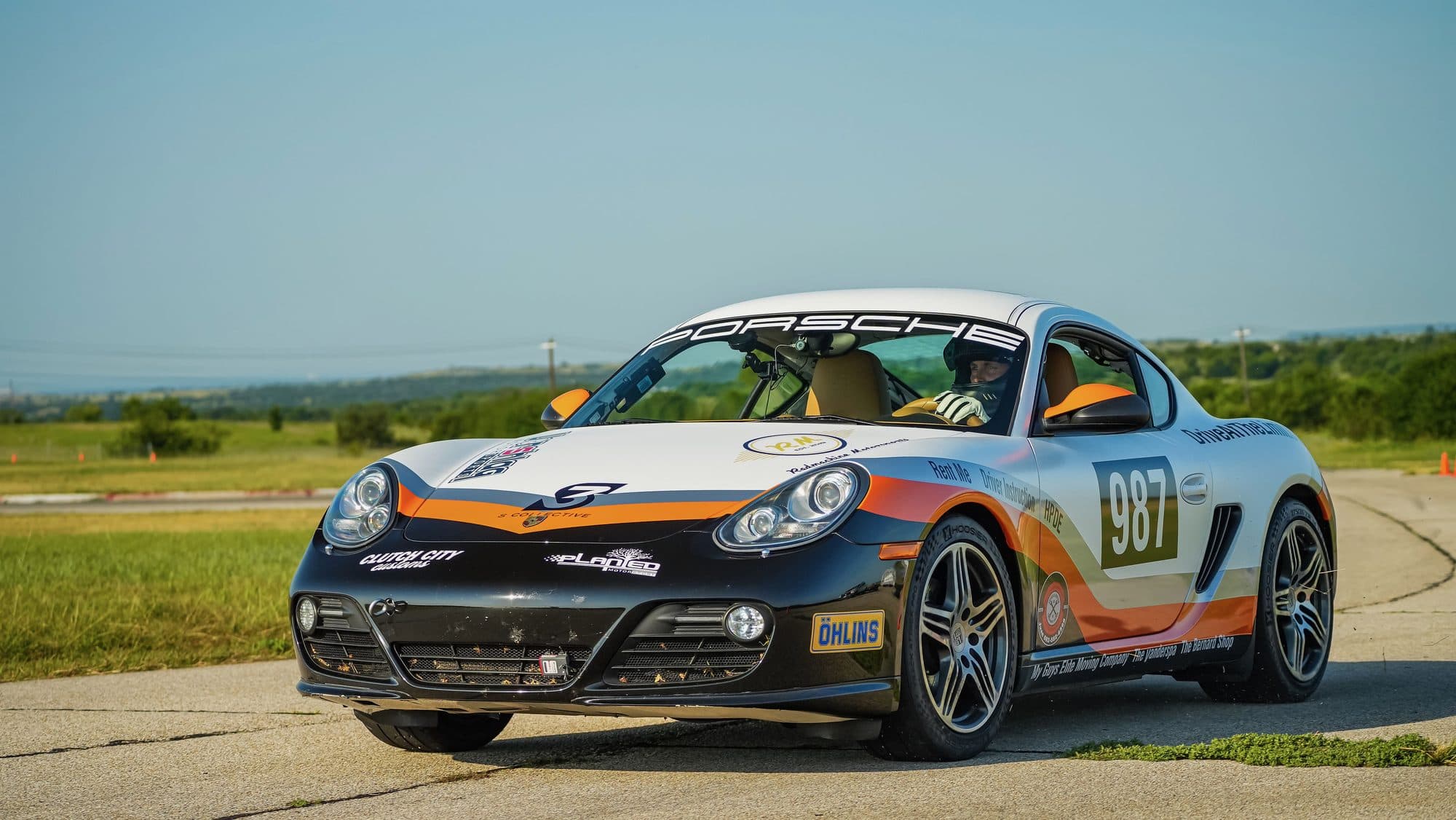 The Drive At The Limit Porsche 987 Cayman, front three-quarter on track at Motorsport Ranch Cresson