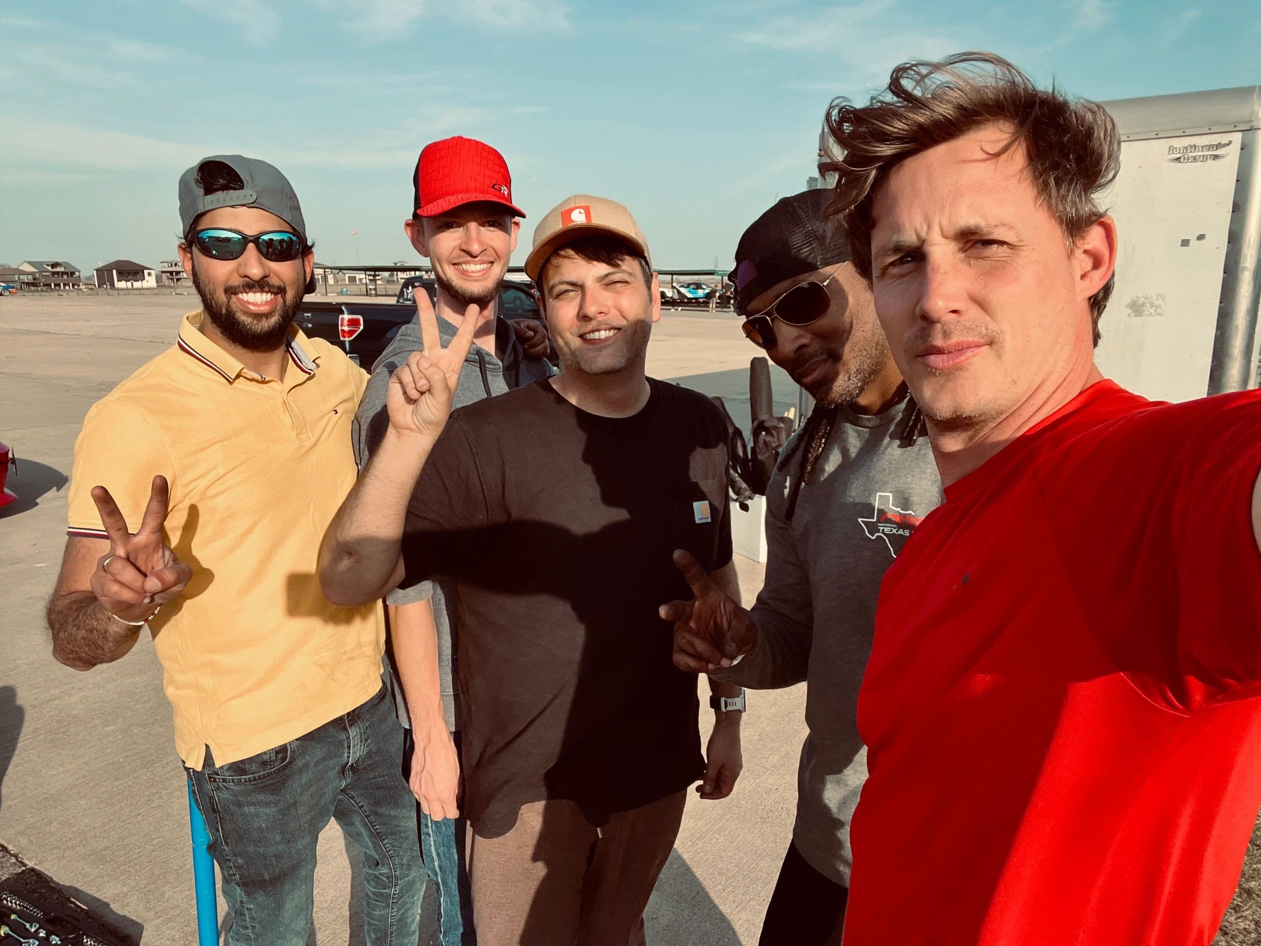 Drivers and coach together at the track