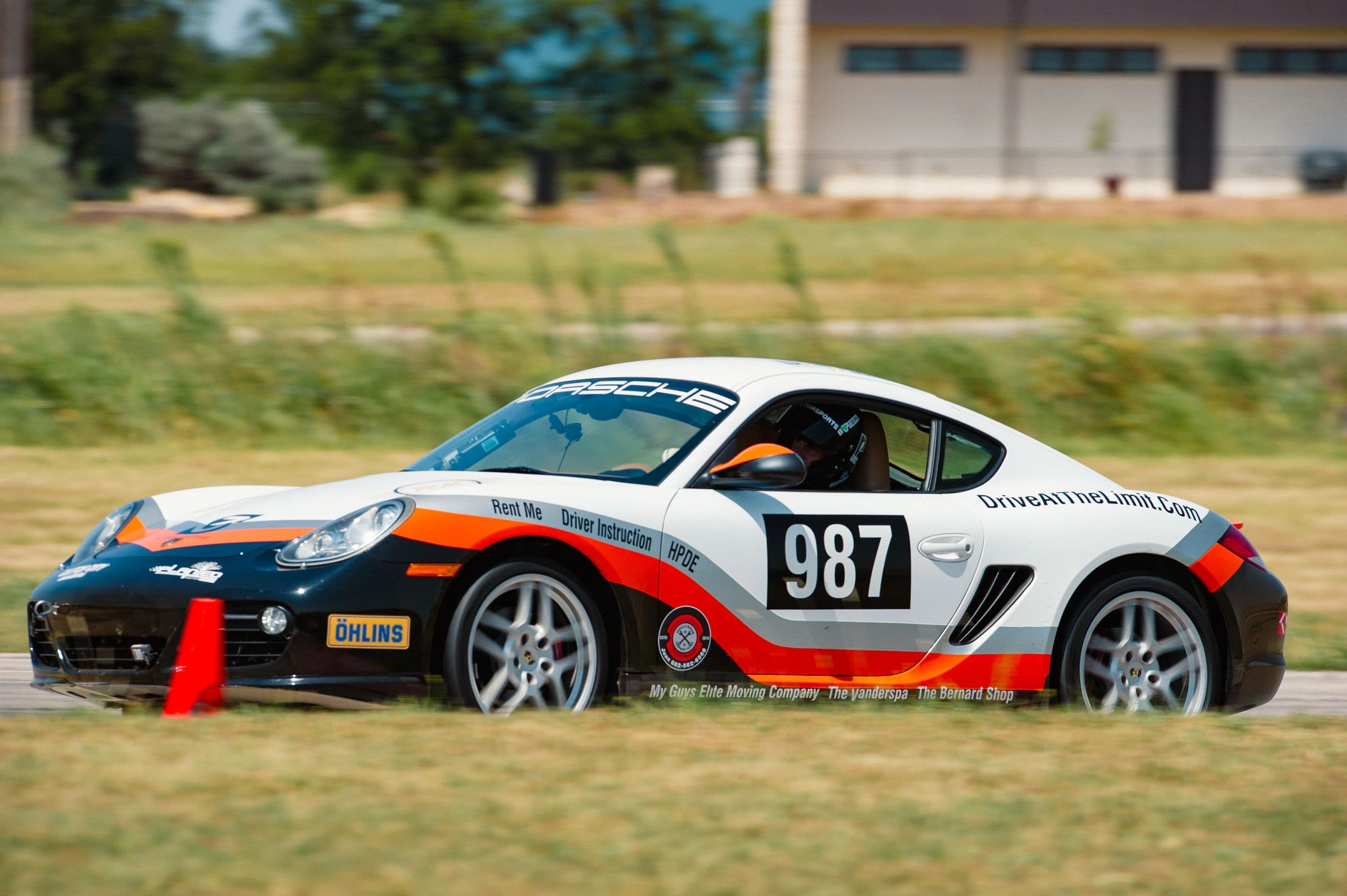 DATL Porsche 987 cornering on track at Motorsport Ranch Cresson