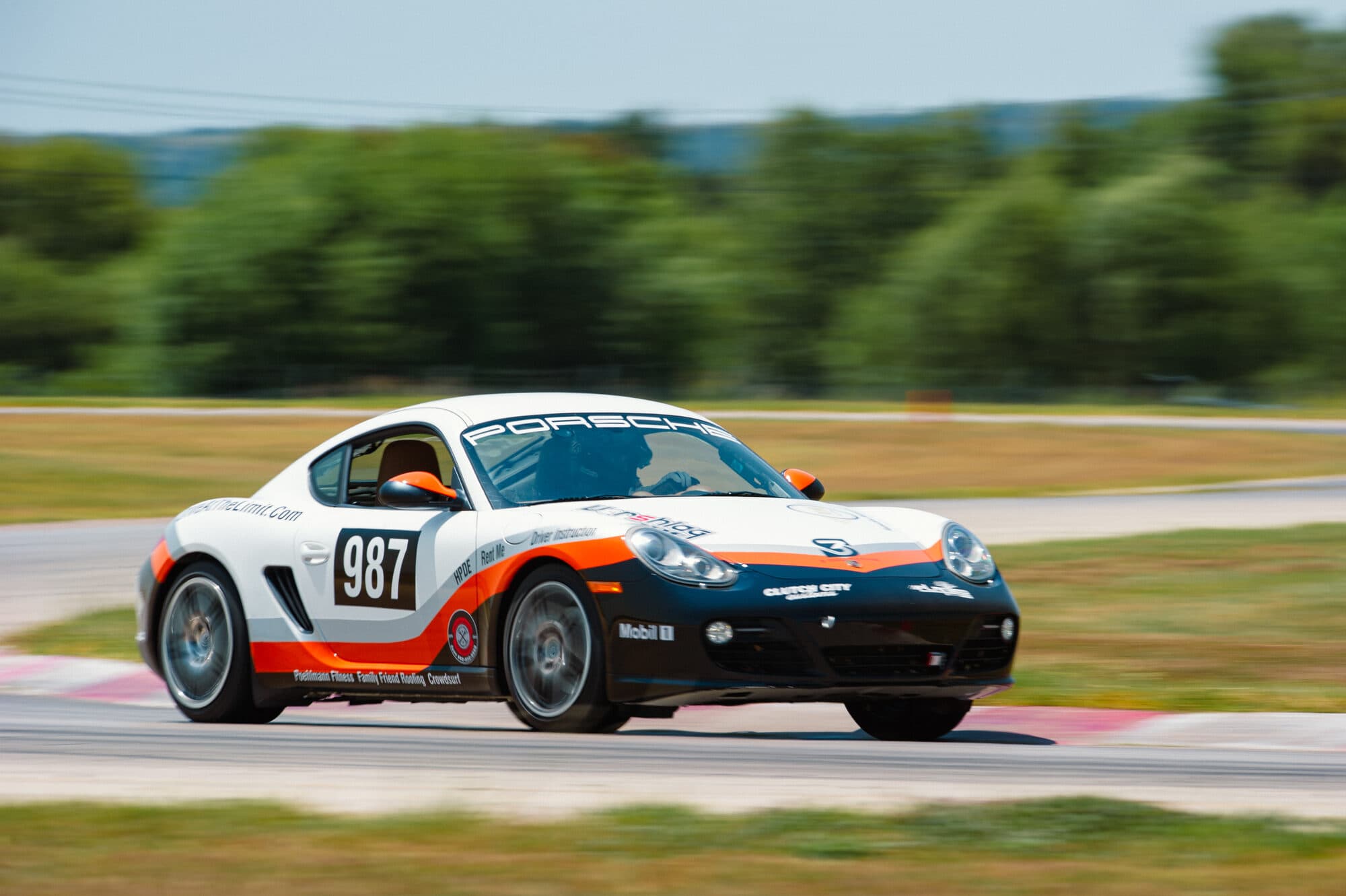 The Drive At The Limit Porsche 987 at speed on track at Motorsport Ranch Cresson